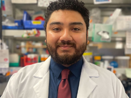 SEO Scholar Gerson Acenscio smiling while wearing lab coat